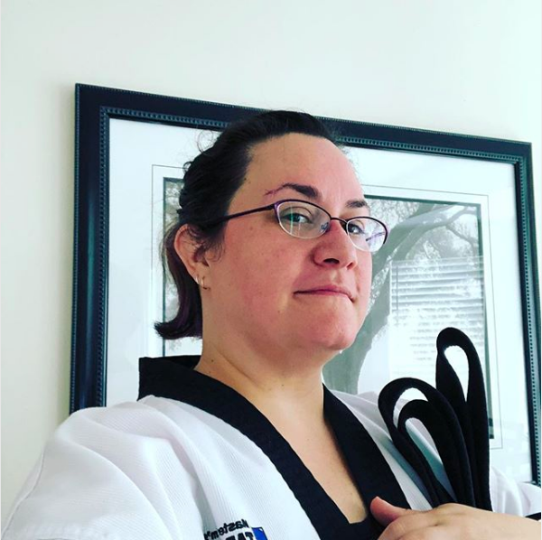 Here I am at home in my uniform post-TKD class holding my belt. A little red and sweaty but really happy.